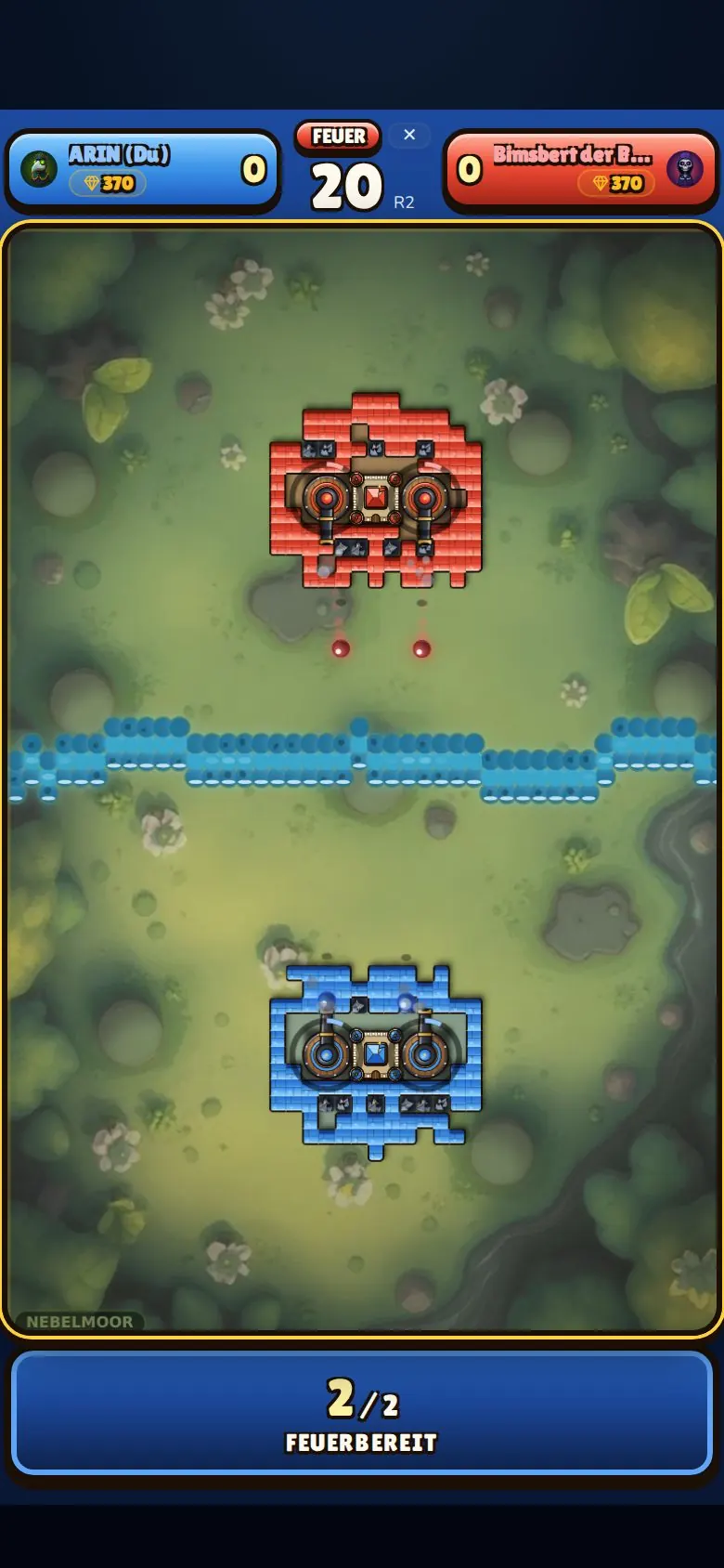 A match in the shooting phase on an iPhone: two walled castles with cannons, a river in between.